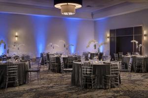 a ballroom with tables and chairs and a room filled with tables and chairsktop at Westchester Marriott in Tarrytown