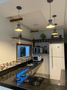 a kitchen with a stove and a white refrigerator at Villa Prado in Prado