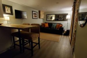 a living room with a table and a couch at 1 bedroom basement apartment with free parking in Brampton