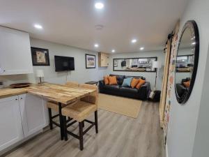a kitchen and living room with a table and a couch at 1 bedroom basement apartment with free parking in Brampton