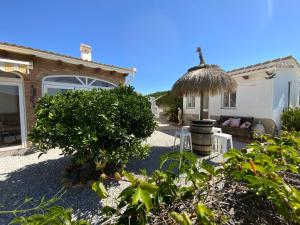 a backyard with a house with a cat on the roof at Casa Hollandia in Viñuela