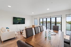 a living room with a table and chairs at York St Apartments in Geelong