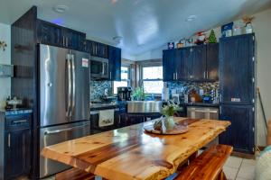 a kitchen with a wooden table and a stainless steel refrigerator at Home away from home. in Wisconsin Dells