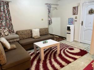 a living room with a couch and a coffee table at 14 Min from cairo airport in Cairo