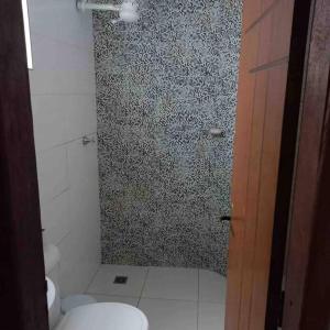 a bathroom with a shower with a toilet at Casa de Veraneio IOS in Ilhéus
