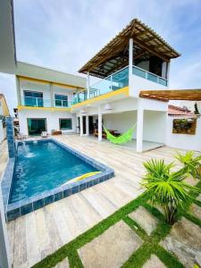 a house with a swimming pool in front of it at Villa Prado in Prado