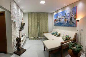 a living room with a couch and a painting on the wall at Villa Prado in Prado