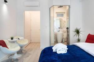 a bedroom with a bed and a sink and a mirror at Lux Nest II City Apartment URBAN STAY in Zagreb