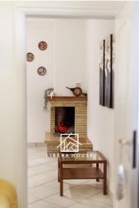 a living room with a fireplace and a table at LIBERA HOUSE - Sweet Apartments in San Salvo