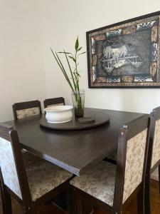 a dining room table with a bowl on top at Apartamento Praça da Liberdade in Belo Horizonte