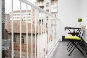 a balcony with a table and chairs on a building at Lux Nest I City Apartment URBAN STAY in Zagreb