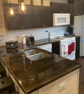 a kitchen with a sink and a stove at Housepitality - The Urban Roost 2 - Location in Columbus