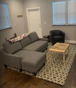 a living room with a couch and a coffee table at Housepitality - The Urban Roost 2 - Location in Columbus