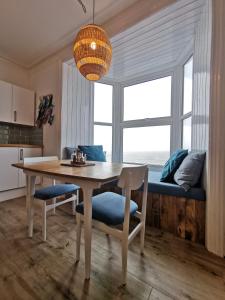 a kitchen and dining room with a table and chairs at Lovely Seafront 2 bed flat in Aberystwyth in Aberystwyth