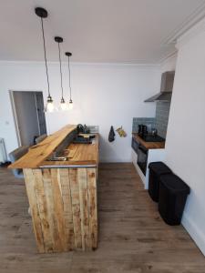 a kitchen with a wooden counter in a room at Lovely Seafront 2 bed flat in Aberystwyth in Aberystwyth