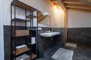 a bathroom with a sink and a mirror at Neu! Auszeit in der Bergen in Wertach