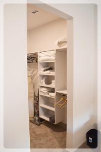 a closet with white shelves in a room at Atlanta at The Interlock Lux Escape in Atlanta