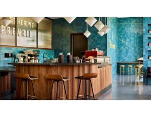 a bar in a restaurant with stools at a counter at Atlanta at The Interlock Lux Escape in Atlanta