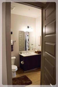 a bathroom with a sink and a toilet and a mirror at Atlanta at The Interlock Lux Escape in Atlanta