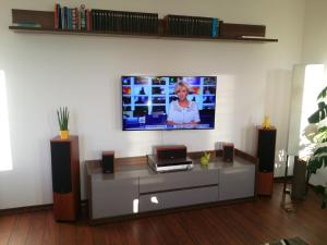 a living room with a flat screen tv on a wall at Apartament Słupsk in Słupsk
