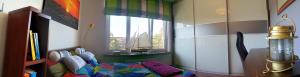 a room with a bed and a boat in a window at Apartament Słupsk in Słupsk +23 photos