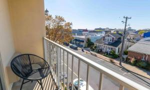 a balcony with a chair and a view of a city at Cape Suites Room 1 - Free Parking! Hotel Room in Rehoboth Beach