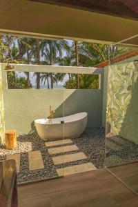 a bathroom with a tub and a glass wall at Catalina's Hideaway in Santa Catalina
