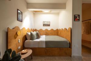 a bedroom with a large bed with a wooden headboard at NOA by DW in San Juan