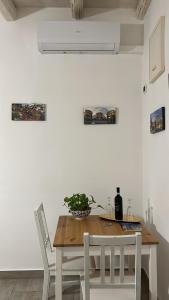 a dining room with a wooden table and chairs at Loft Ballarò in Palermo