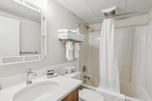 a bathroom with a sink and a toilet and a mirror at Cape Suites Room 2 - Free Parking! Hotel Room in Rehoboth Beach