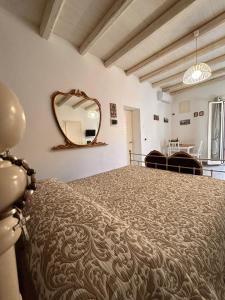 a bedroom with a large bed with a mirror on the wall at Loft Ballarò in Palermo