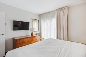 een slaapkamer met een bed, een dressoir en een televisie bij Cape Suites Room 4 - Free Parking! Hotel Room in Rehoboth Beach