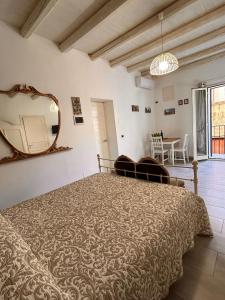 a bedroom with a large bed and a mirror at Loft Ballarò in Palermo