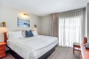 a hotel room with a large bed and a window at Cape Suites Room 7 - Free Parking! Hotel Room in Rehoboth Beach