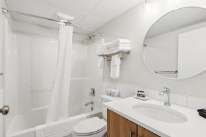 a bathroom with a sink and a toilet and a mirror at Cape Suites Room 3 - Free Parking! Hotel Room in Rehoboth Beach