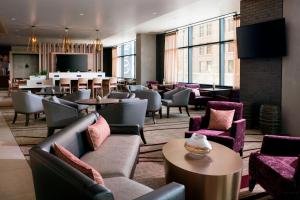 a restaurant with couches and tables and a bar at Residence Inn by Marriott Phoenix Downtown in Phoenix