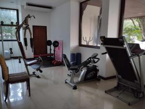 a gym with two tread machines and a mirror at Aster Residence in Chiang Mai