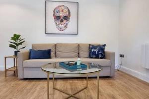 uma sala de estar com um sofá e uma mesa em Beautiful Apartment Overlooking a Garden em Londres