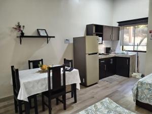 a kitchen with a table and a kitchen with a refrigerator at Villa jr 4 by Villas Oasis Guacalillo in Tárcoles