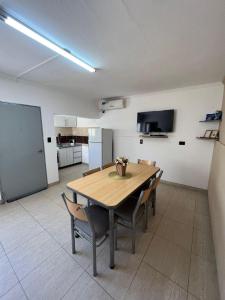 a dining room with a wooden table and chairs at Complejo Sucre I in San Luis