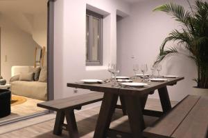 a dining room table with wine glasses on it at Amy Villa , Agios Prokopis in Agios Prokopios