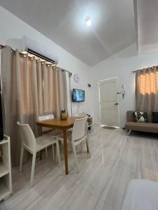 a living room with a table and chairs and a couch at Bungalow House-Olango Island in Lapu Lapu City