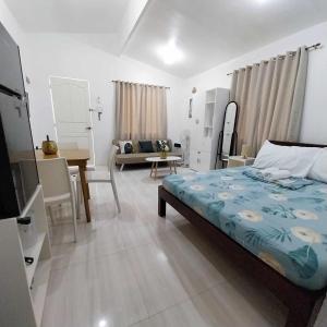 a bedroom with a bed and a living room at Bungalow House-Olango Island in Lapu Lapu City