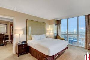 a hotel room with a large bed and large windows at MGM Signature-07-802 1Br 2Ba Balcony Suite in Las Vegas