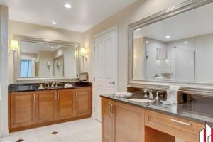 a bathroom with two sinks and a large mirror at MGM Signature-07-802 1Br 2Ba Balcony Suite in Las Vegas