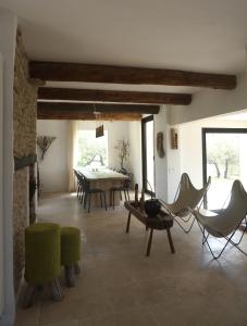 a large living room with a table and chairs at L'arcadie Du Souleyan in Oppède