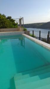a swimming pool with a view of the water at Puesta del Sol Apart in Puerto Iguazú