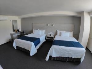 Voodi või voodid majutusasutuse Kasa Hotel & Suites toas