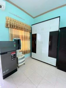 a large room with a kitchen with a refrigerator at Homeatay & Apartment CHÂU SƠN in Vung Tau