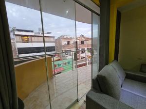 a room with a balcony with a view of a building at Departamento en Huanchaco Beach in Huanchaco